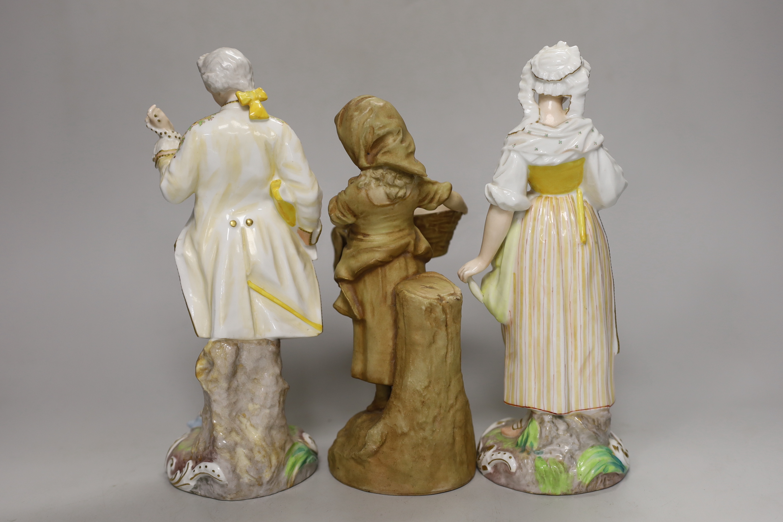 A pair of 19th century German porcelain figures, 22cm, and another